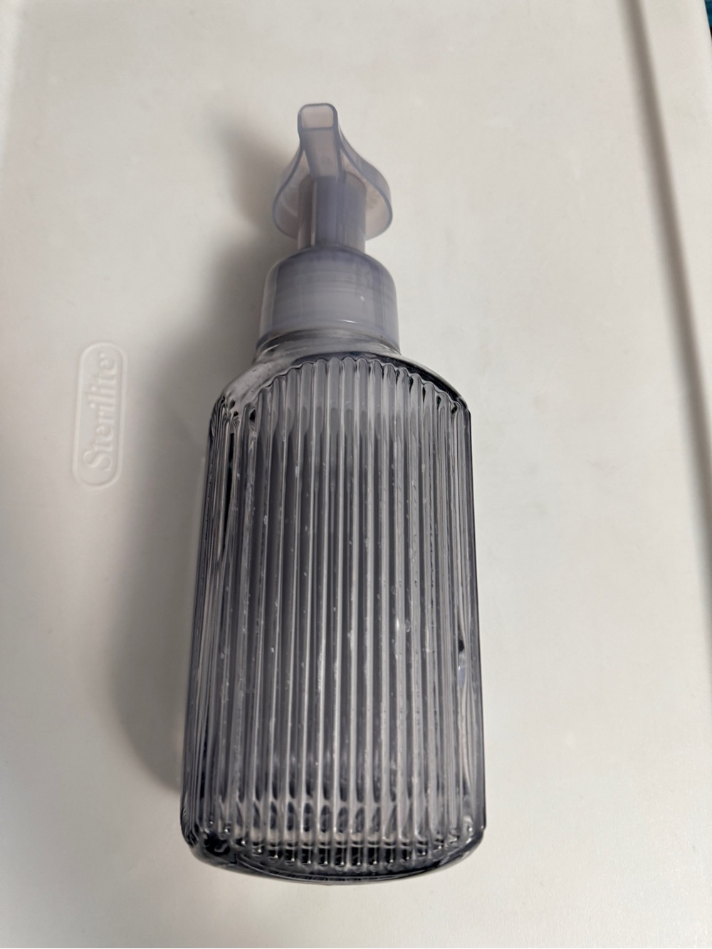 Bath and Body Works gray ribbed glass foaming soap dispenser.